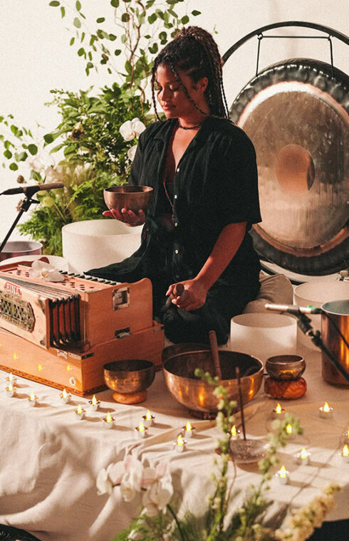 a girl with a bowl and a gong behind