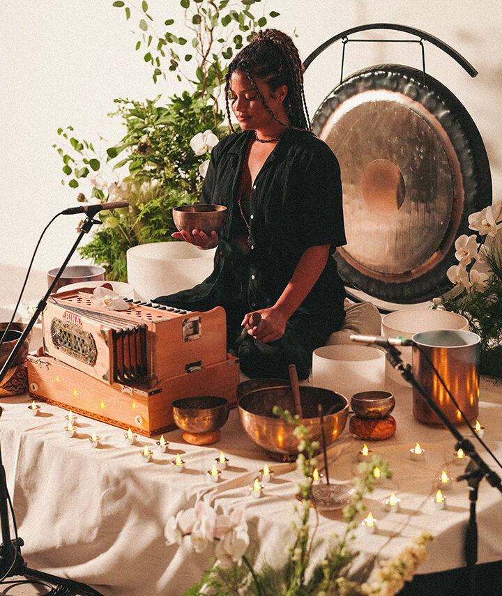 a girl with a bowl and a gong behind