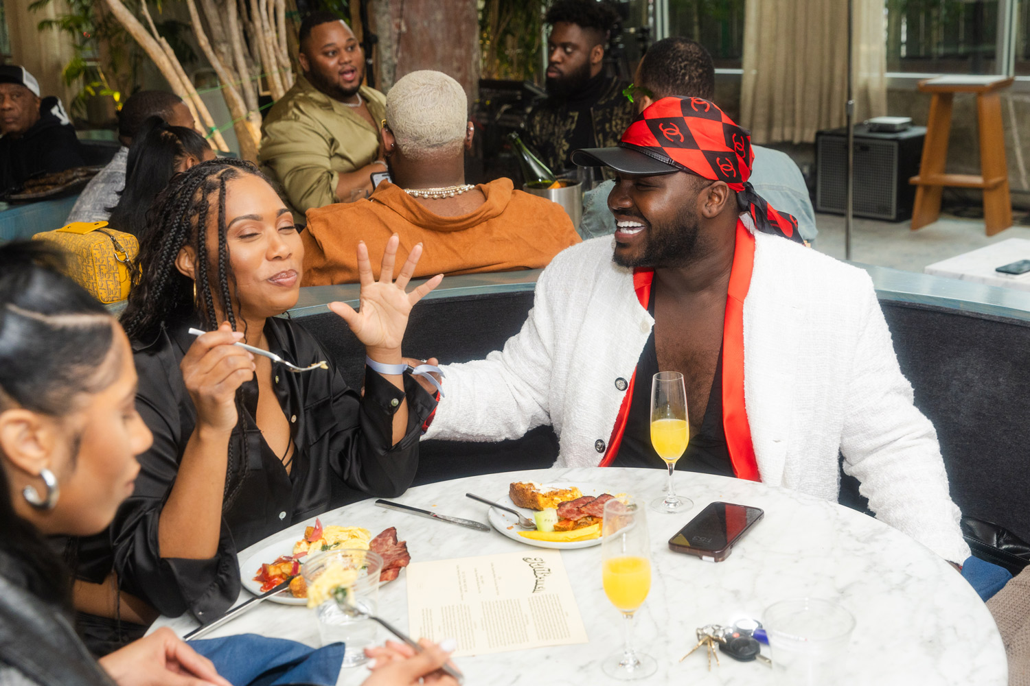 People laughing and eating in a round table