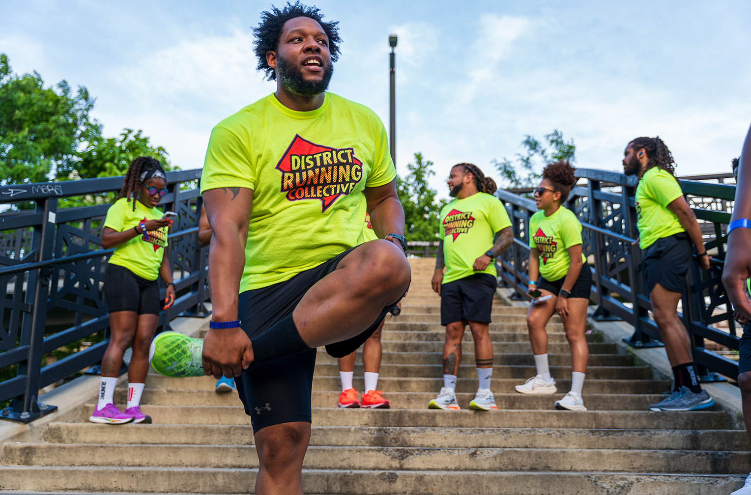 A group of people is warming up together in preparation for their run.