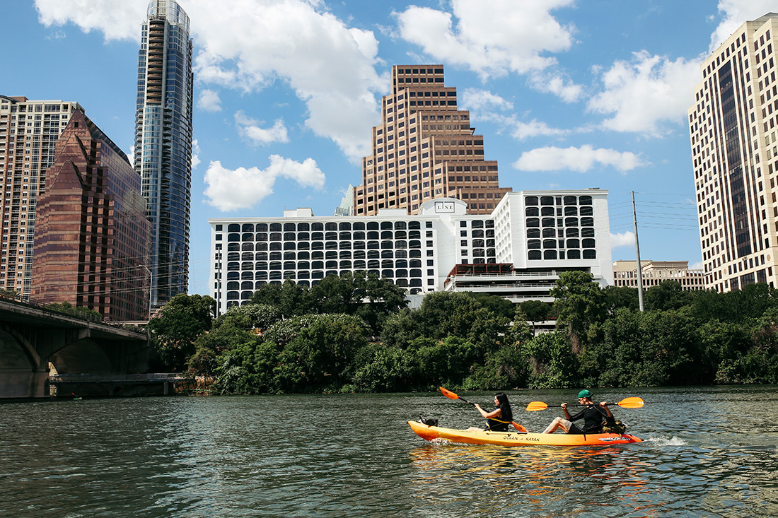 High rise buildings by the lake where there were people canoeing