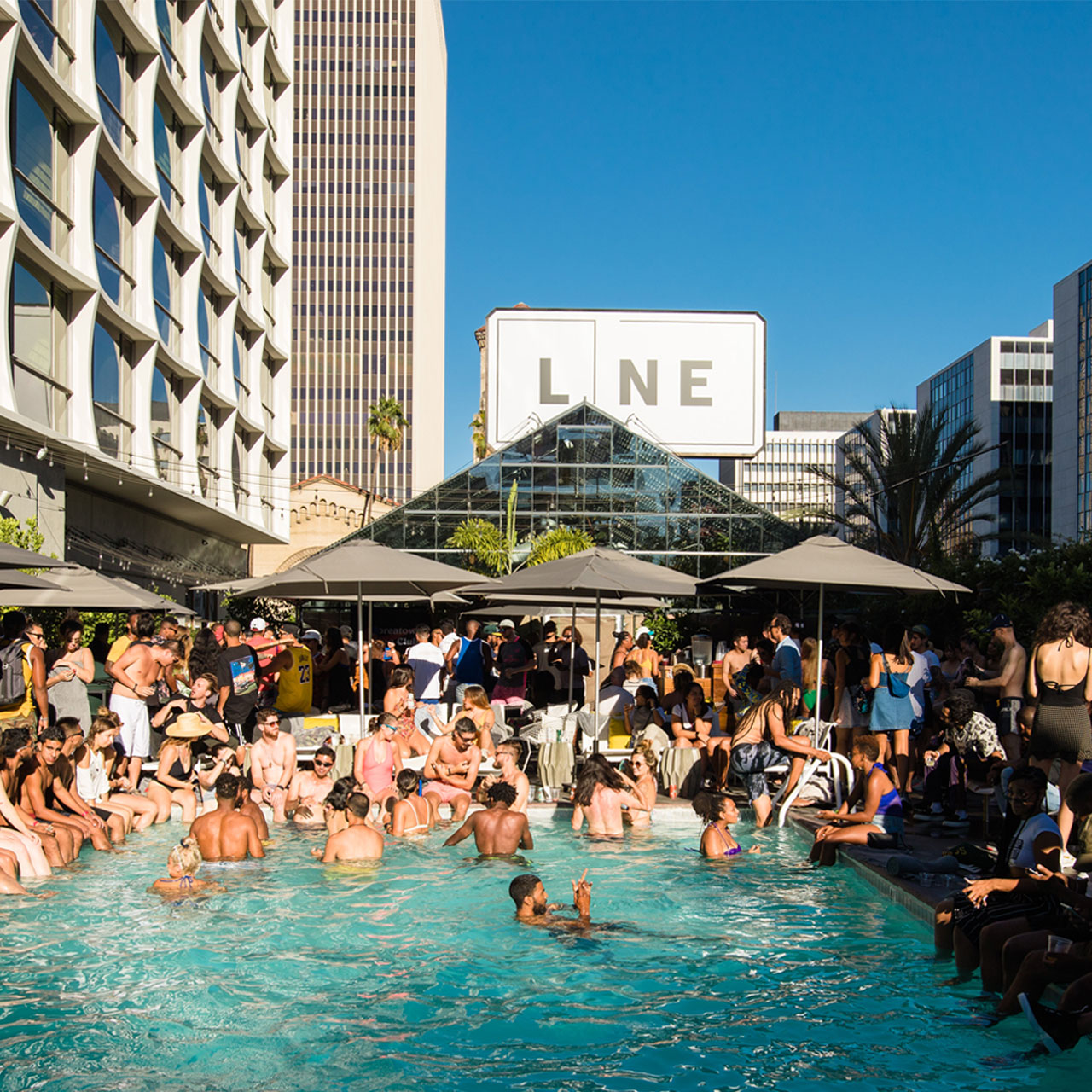 Pool area with crowded with people