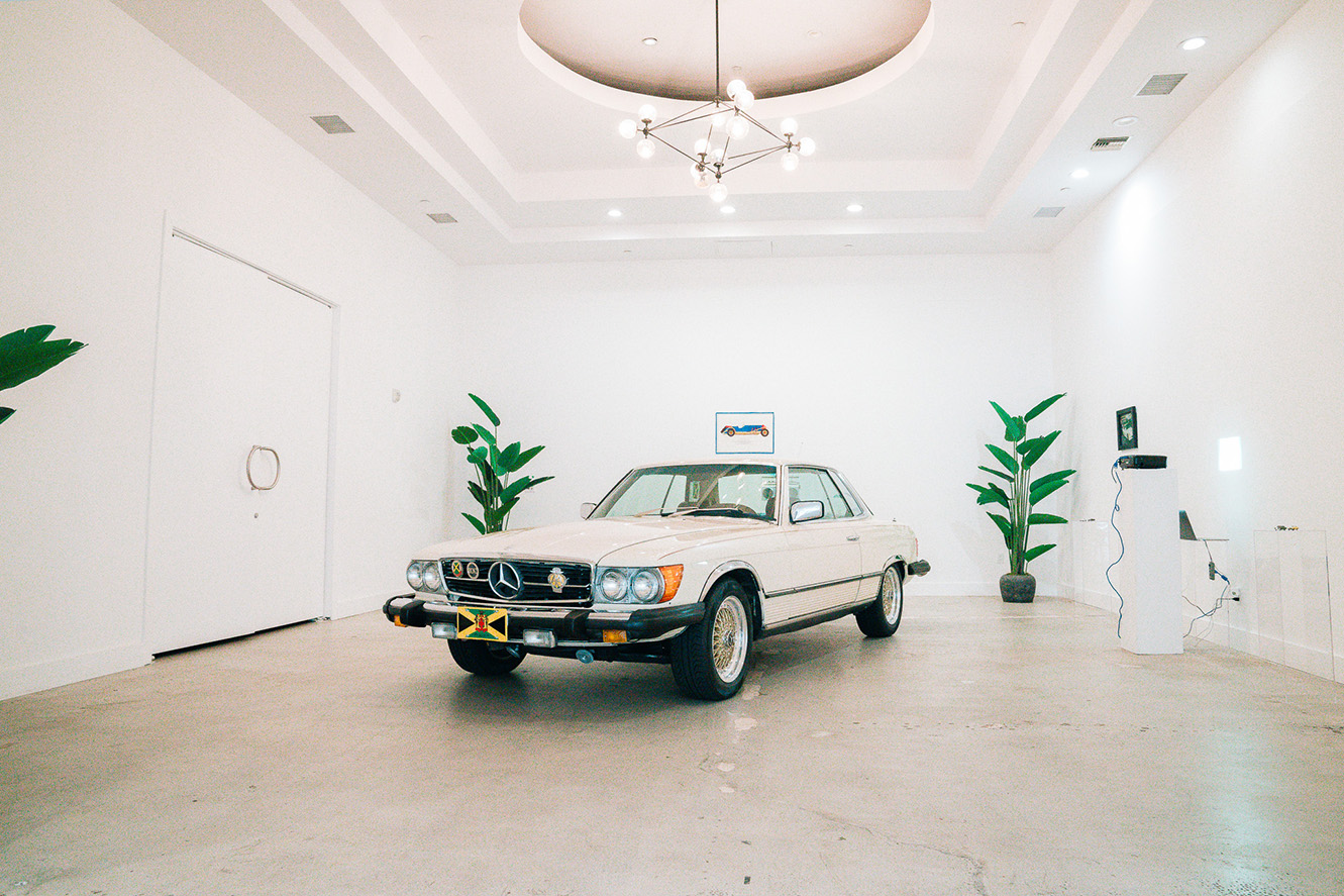 a car displayed in a large white hall