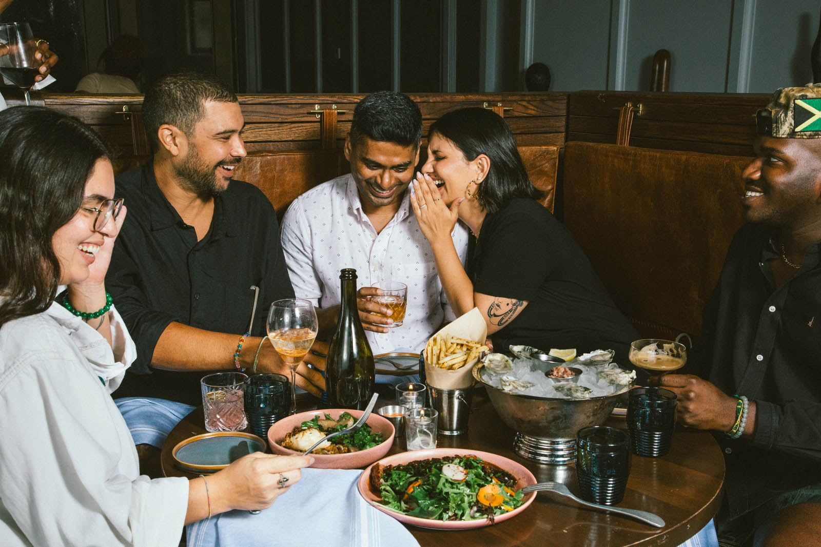 a group of people around table full of food and drink