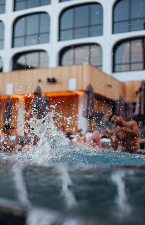 Picture of swimming pool with people on the ramp