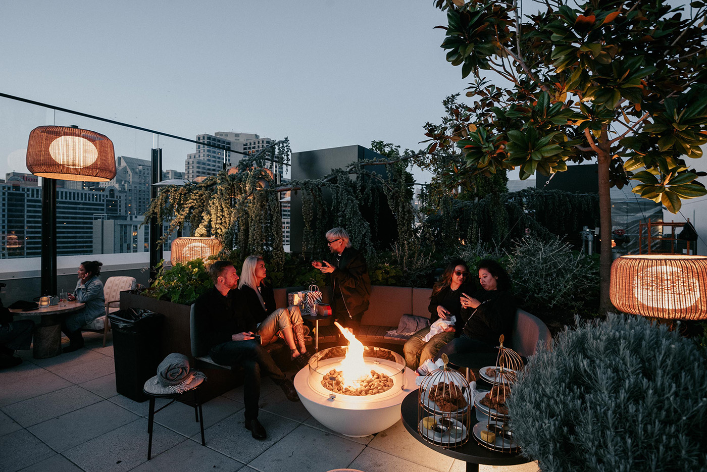 a group of people hanging out around a firepit